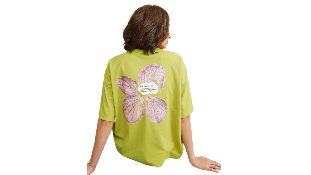 Lime green Rareism oversized t-shirt with inspirational text patch and pastel purple floral design.